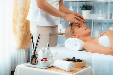 Caucasian woman enjoying relaxing anti-stress head massage and pampering facial beauty skin...