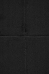 Close-up of dark, almost black paper featuring a subtle texture with visible horizontal and...