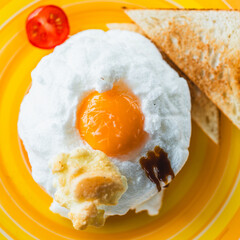 Orsini egg with microgreens and toast on a yellow plate. View from above. Healthy breakfast concept