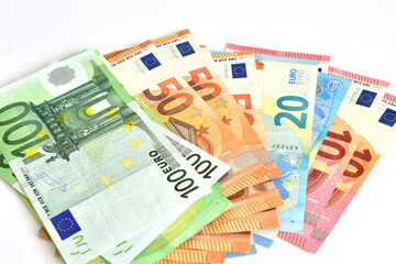 European currency of different denominations lies on a white background