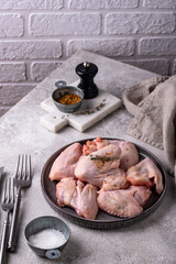 Raw chicken wings on black background.