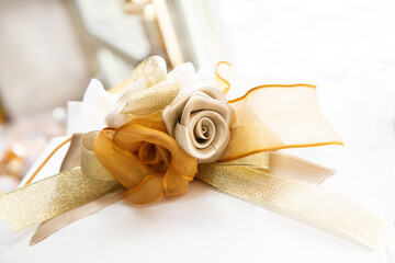 Textile gold and light brown roses with ribbon
