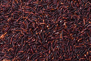 Red or brown raw rice in a ceramic bowl