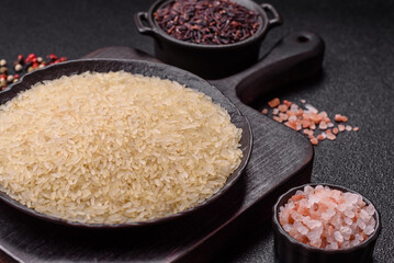 White raw rice in a ceramic bowl. Rice as an ingredient