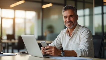 Mature Hispanic Businessman CEO Using Mobile App and Laptop in Office