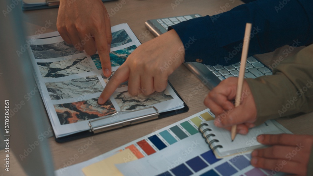 Poster a group of individuals collaborating on a design project, highlighting their hands selecting colors 