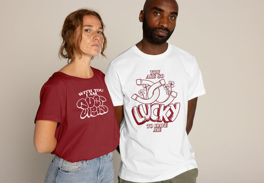 Multiracial Couple Displays Trendy T-Shirt Designs. PSD mockup