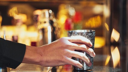 Closeup mixing hand bartender holding jigger to measure sugar salt all of ingredients into shaker...