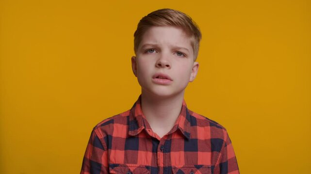 Boy Shaking Head Saying 'No No No' on Yellow Background
