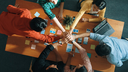 Smart team putting hand together while brainstorm about Ux Ui design for mobile phone interface....