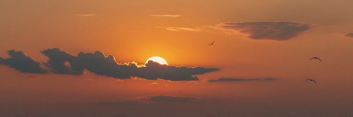 Obraz premium A serene sunset scene with fluffy clouds and birds gliding through the colorful sky