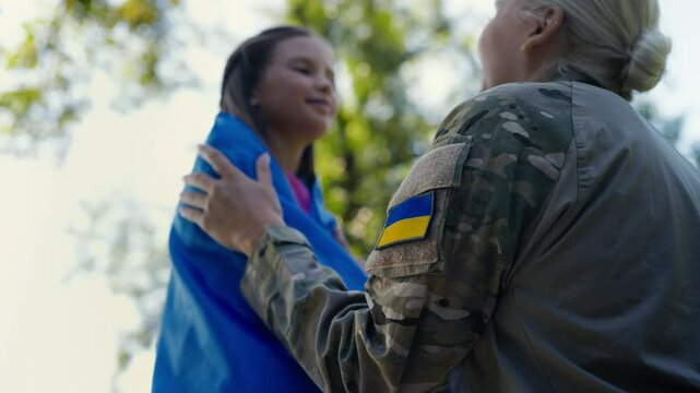 Ukrainian military mother wraps daughter in national flag, love for homeland