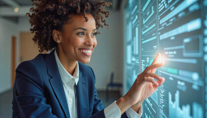 A portrait headshot photo of a friendly professional CEO executive business worker: A smiling African American woman in a business suit confidently interacts with a large digital display showing 