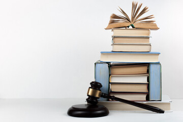 Law concept open book with wooden judges gavel on table in a courtroom or law enforcement office,...
