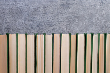 open book, books on the gray concrete background. Back to school. Education. Copy space for text.