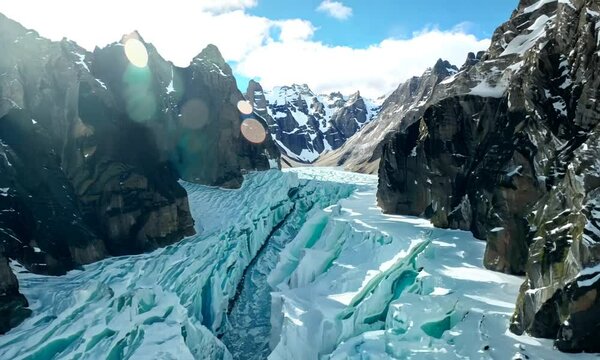 Breathtaking scenery of the Bezengi Glacier in the Bezengi Gorge. Snow-capped mountains. Wild untouched nature of the Caucasus Mountains. Bezengi Gorge. White clouds Aerial view