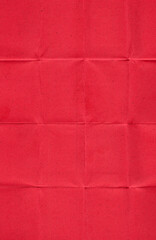 real scan of red paper with visible horizontal and vertical fold lines, creating a grid-like...