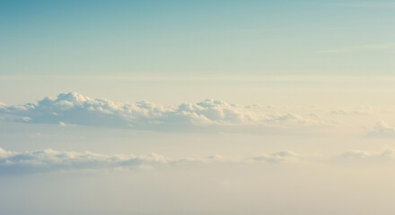 Serene Aerial View of Soft Cumulus Clouds and Hazy Sky at Dawn or Dusk