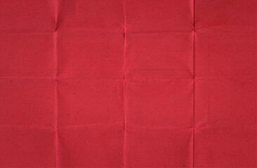 Fototapeta premium Folded Red Handmade Paper with Visible Creases and Speckled Texture