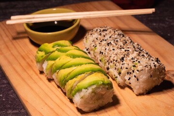 fresh sushi portions with rice, avocado and sesame seeds