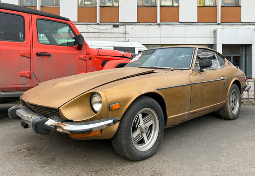 Detail of a classic Japanese Datsun 260 Z, parked at the street. Nissan 260 Z sport car. Abandoned Classic Datsun 260Z sports car parked on street. Japanese car.