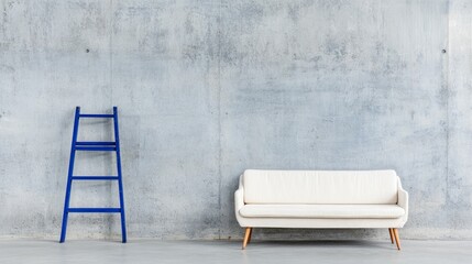 Blue ladder and white couch positioned against a concrete wall