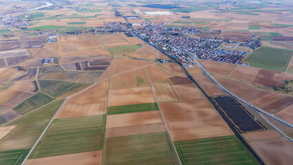 Fototapeta premium Drone view of farmland in Straubing-Bogen, Bavaria, Germany, with vast agricultural fields stretching across the region