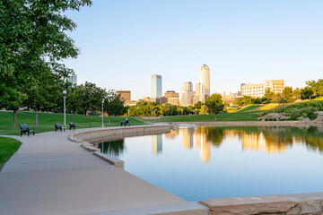 Fototapeta premium Omaha skyline reflecting in Gene Leahy Mall water feature at blue hour
