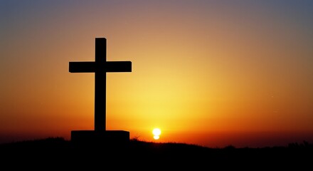 Silhouette of a Cross on Hill with Sunset and Orange Sky