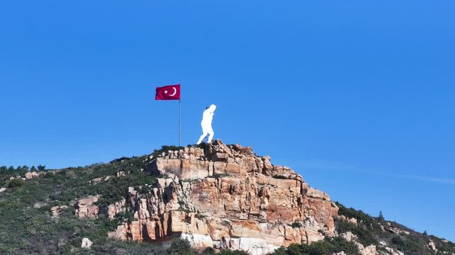 Turkish flag and Ataturk statue waving on top of the mountain - 4k footage of waving Turkish flag and Ataturk statue, the founder of T&uuml;rkiye, taken from the air by drone