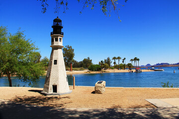 Replica of the Buffalo Main and Currituck Beach lighthouses on the Bridgewater Channel in Lake Havasu City, Arizona, USA on lake Havasu with blue sky copy space and California mountains.