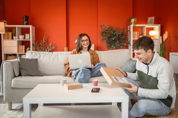 Two friends boyfriend and girlfriend enjoy a moment with a package