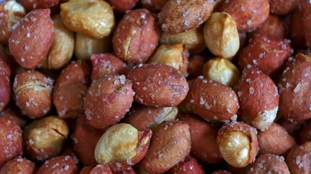 Top view close up footage of salty peanut rotating. Food concept.