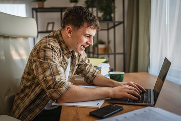 young man student learn and prepare exam from notebook and laptop