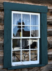 Church reflection in the window of an old house 