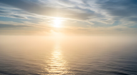 Obraz premium Serene seascape with sunlit water, soft mist, and atmospheric sky