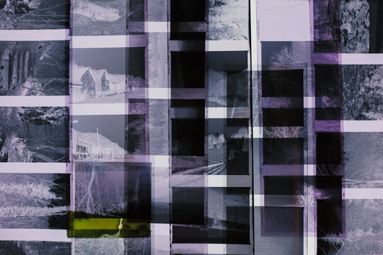 Vintage medium format film negatives arranged in overlapping layers, creating abstract geometric pattern. Black and white photographic strips with travel memories 