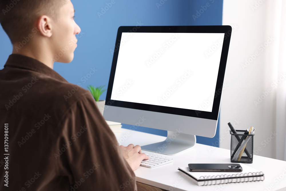 Poster man working on computer at white desk in office. mockup for design