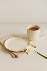 Easter Breakfast Scene with Tea, Flower and Ceramic Plate