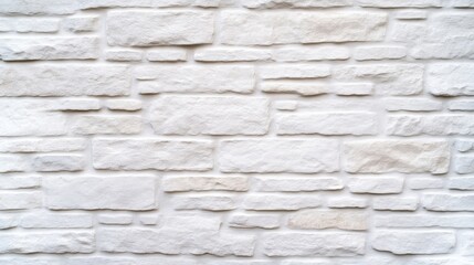 Fototapeta premium White stone wall texture. A close-up view of a wall made of rectangular white stones, creating a rustic, natural look