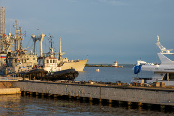 Kronstadt, Russia - 07.27.24. Harbor View with Ships and Lighthouse in Distance.