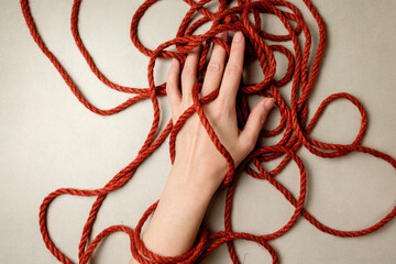Intricate interplay of natural jute rope and hand in Japanese bondage art