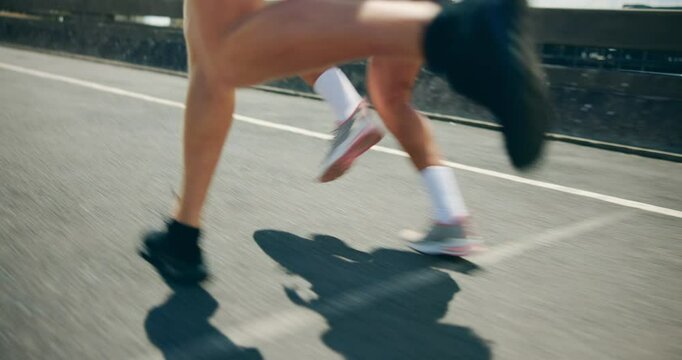 People, feet and running in city for fitness, cardio challenge and workout speed for endurance. Urban, friends and handheld on road for practice, intense exercise and marathon for muscle development