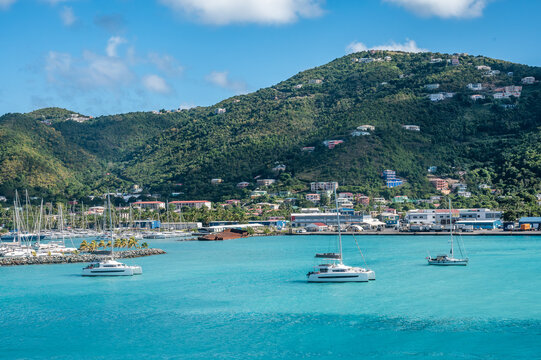 Beautiful view of Road Town harbor in Tortola, British Virgin Islands, with sailboats, turquoise Caribbean waters, colourful hillside homes, and lush green mountains under a blue sky (February 2025)