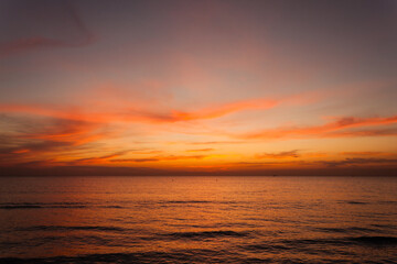 Beautiful bright stunning romantic sunset or sunrise on the horizon of clouds and the turbulent...