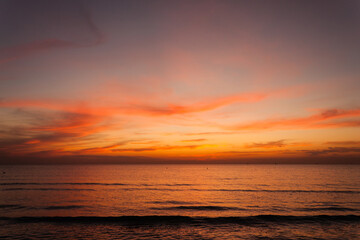 Beautiful bright stunning romantic sunset or sunrise on the horizon of clouds and the turbulent...