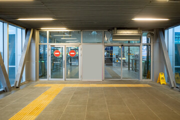 Terminal Interior, Interior hallway of a modern airport with glass door and tile floor.