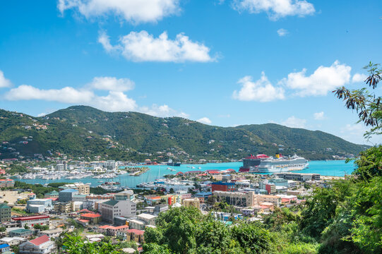 Stunning aerial view of Road Town, Tortola, British Virgin Islands, with vibrant coastal city, lush green hills, turquoise harbor, and large cruise ship docked at the port, Caribbean (February 2025) 