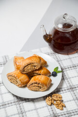 Walnut Roll Cake Slices with Teapot in the Background