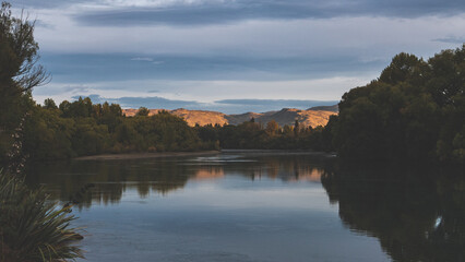 Early morning sunrise in alexandra new zealand clutha river lake peaceful mountains plants nature